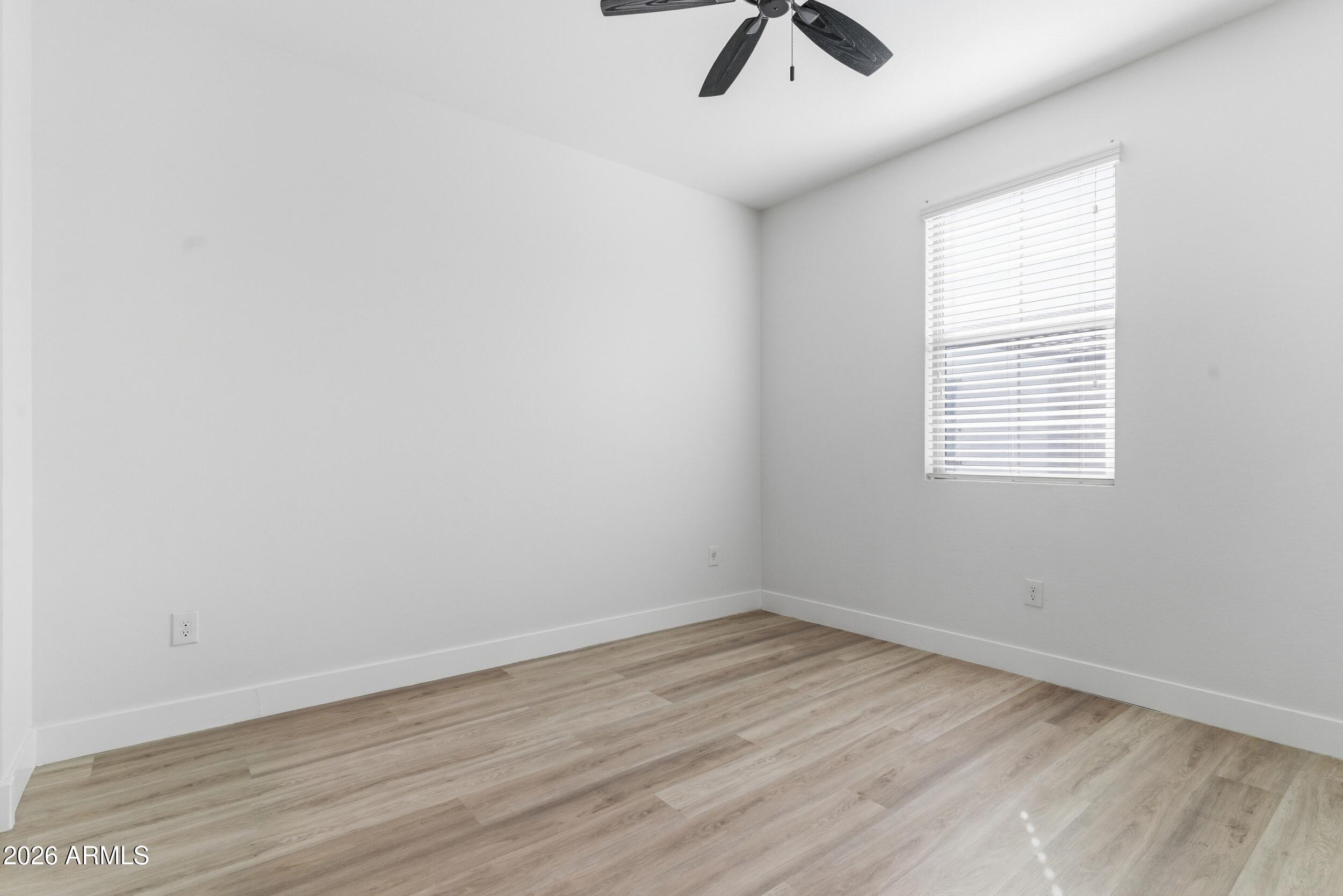 3855 South McQueen Road, Unit 34 Chandler, AZ 85286 - Photo 32 of 48 an empty room with a window and ceiling fan