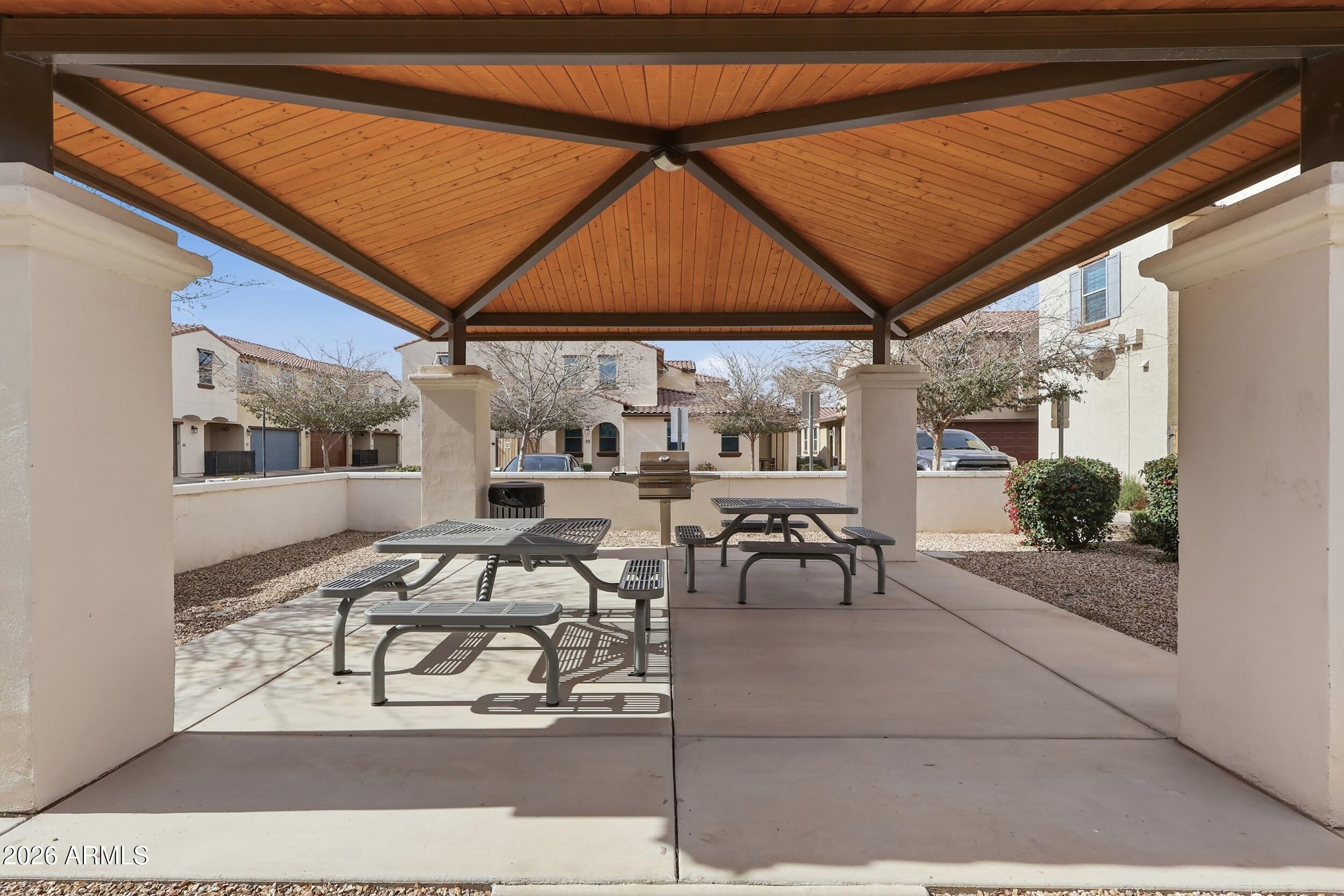 3855 South McQueen Road, Unit 34 Chandler, AZ 85286 - Photo 39 of 48 a view of a patio with table and chairs under an umbrella