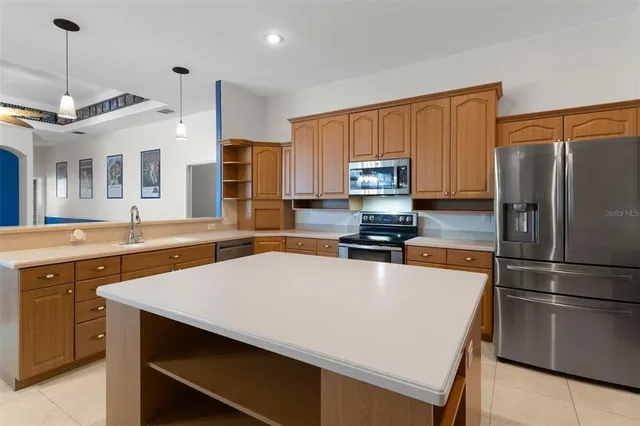 a utility room with lots of clutter and cabinets