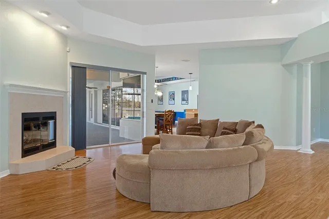 a view of a livingroom with a chandelier furniture and wooden floor