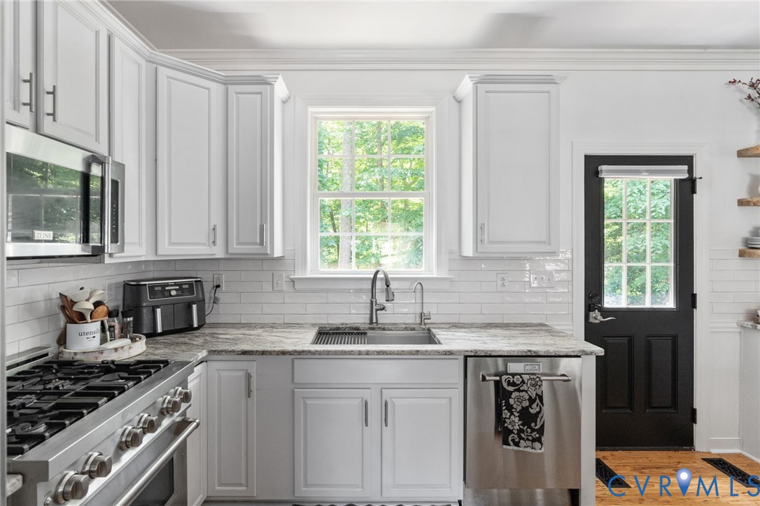 1755 Dispatch Road Quinton, VA 23141 - Photo 26 of 86 a kitchen with stainless steel appliances granite countertop a sink stove and cabinets