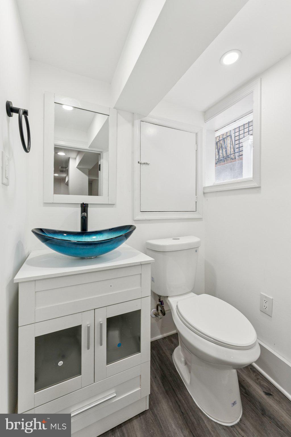 2105 4th Street Northeast Washington, DC 20002 - Photo 27 of 30 a bathroom with a toilet a sink and mirror