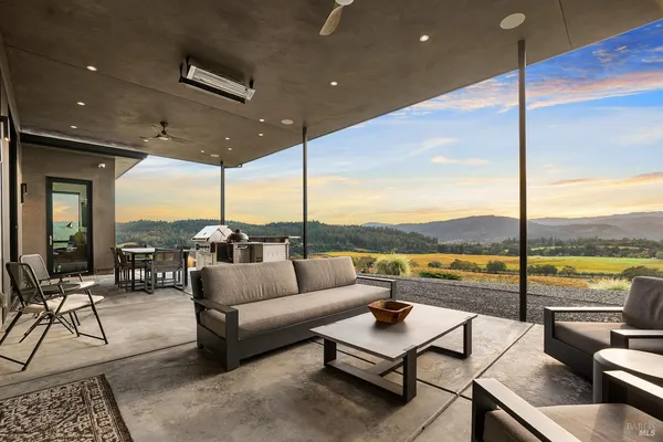 a living room with furniture and a floor to ceiling window