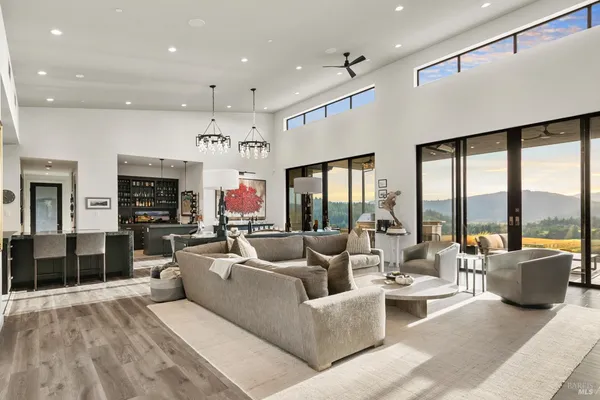 a living room with fireplace furniture and a large window