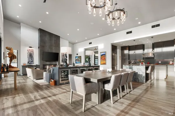 a view of a dining room with furniture wooden floor and chandelier
