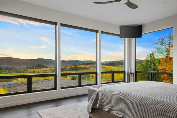 a bedroom with a large bed and a large window