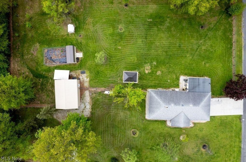 2530 Tuckahoe Road Wooster, OH 44691 - Photo 4 of 29 Expansive property featuring a grey-shingled residence, a large detached outbuilding, a smaller utility shed, and a fenced-in garden area