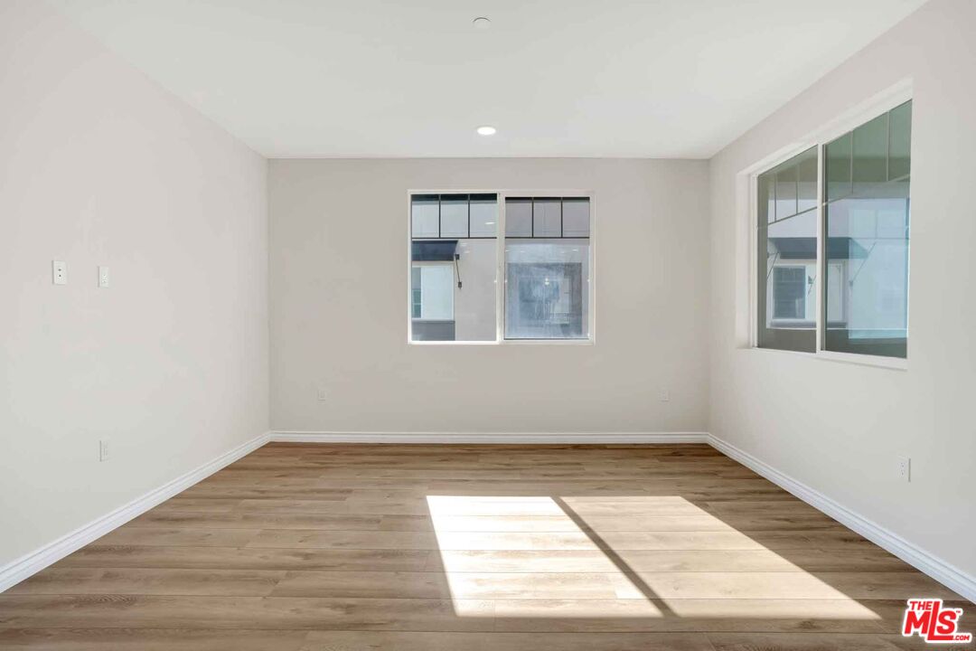 2850 Wagon Wheel Road, Unit 401 Oxnard, CA 93036 - Photo 12 of 31 an empty room with wooden floor and windows