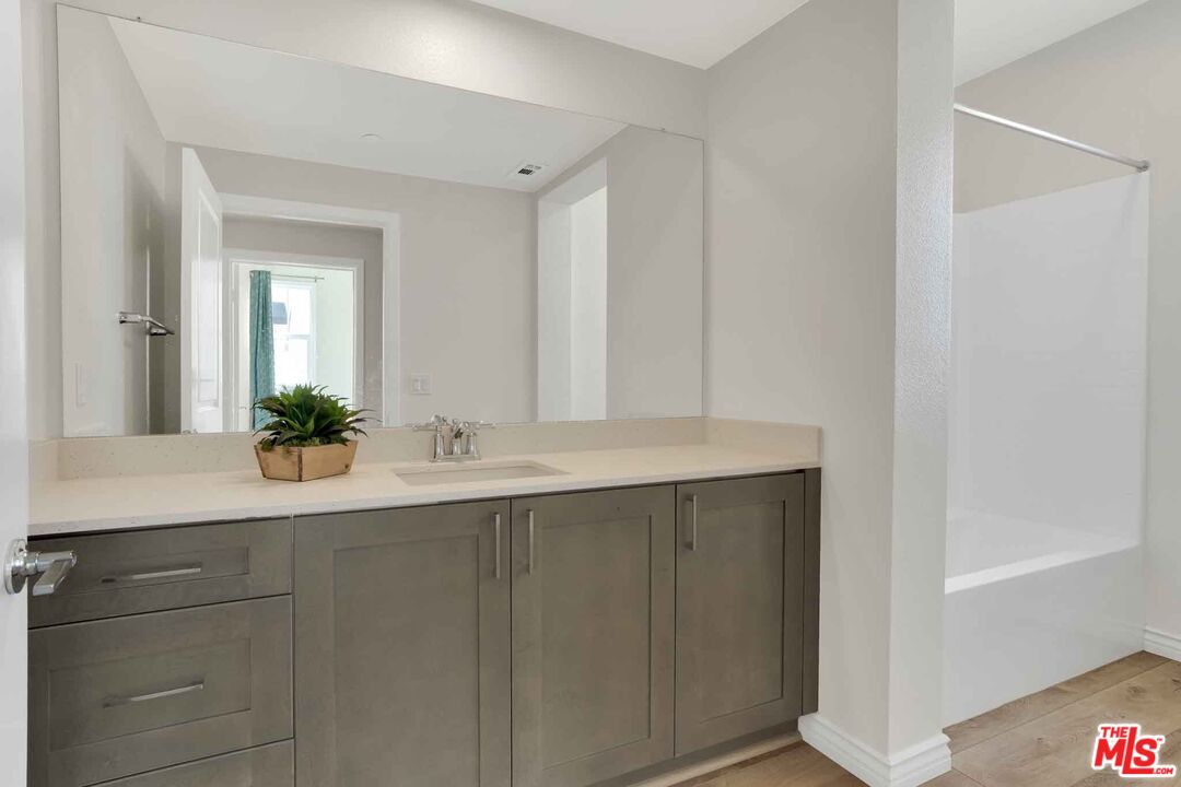 2850 Wagon Wheel Road, Unit 401 Oxnard, CA 93036 - Photo 16 of 31 a bathroom with a sink and a mirror