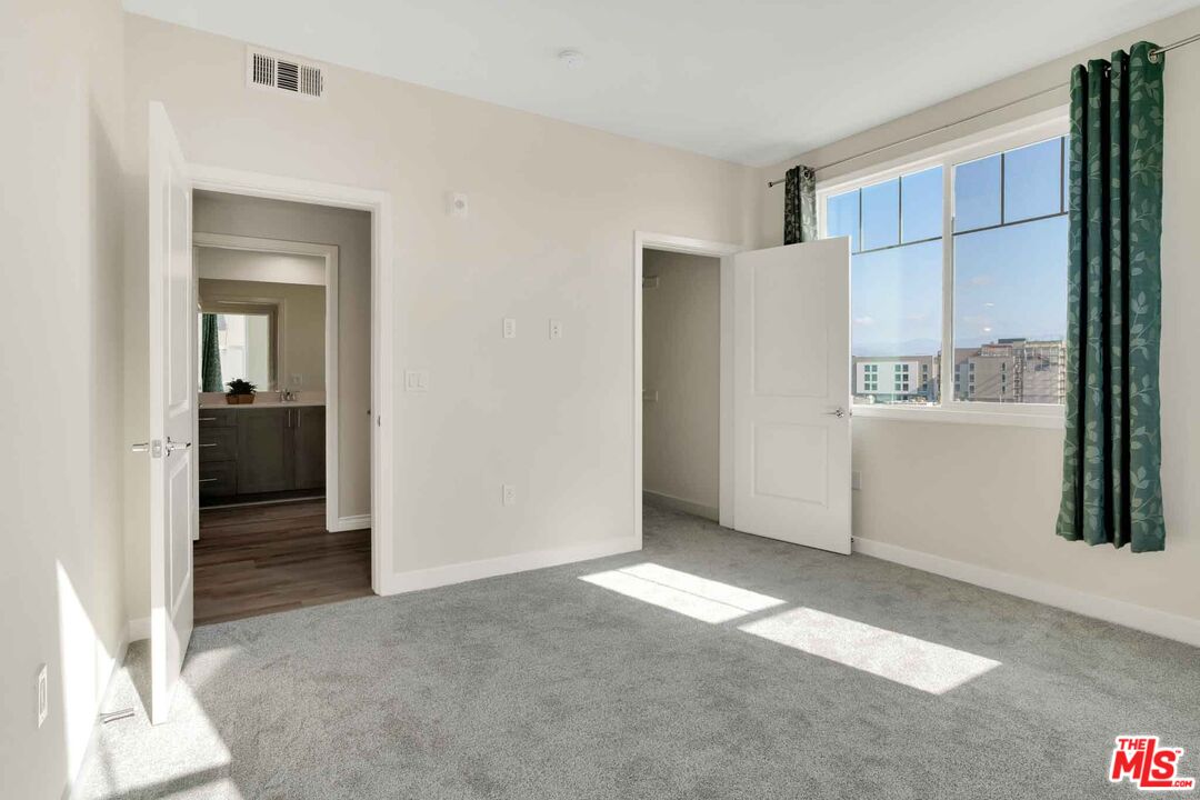 2850 Wagon Wheel Road, Unit 401 Oxnard, CA 93036 - Photo 18 of 31 a view of a big room with closet and windows