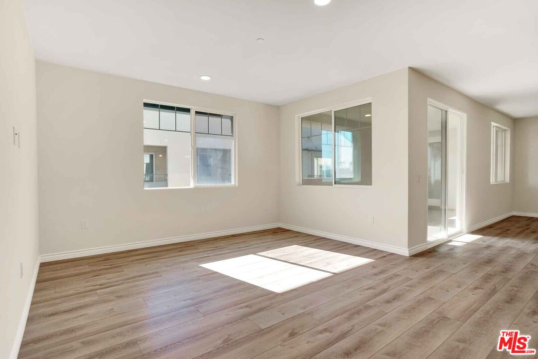 2850 Wagon Wheel Road, Unit 401 Oxnard, CA 93036 - Photo 20 of 31 an empty room with wooden floor and windows