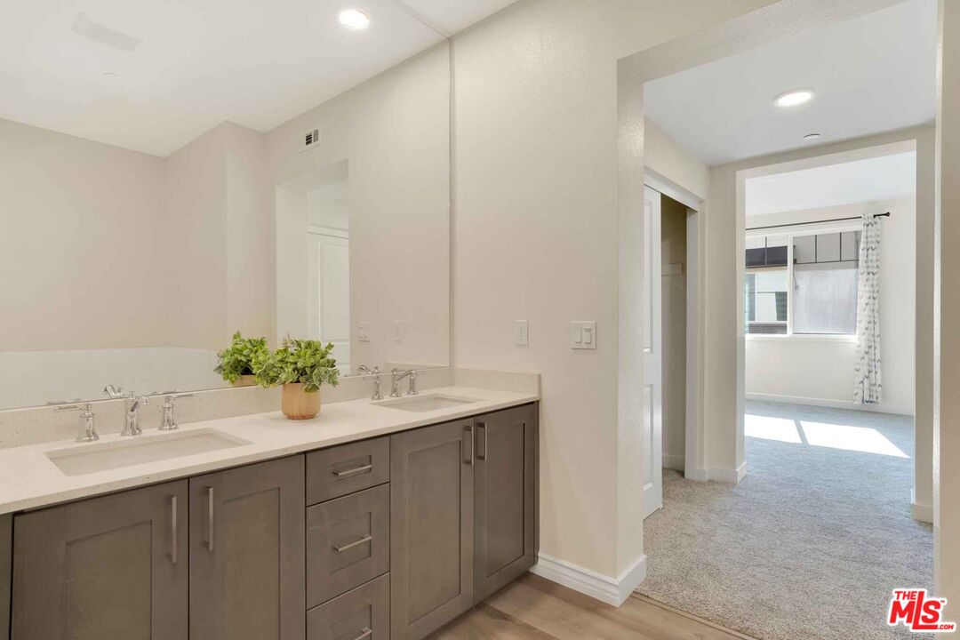 2850 Wagon Wheel Road, Unit 401 Oxnard, CA 93036 - Photo 29 of 31 a bathroom with a sink and a mirror