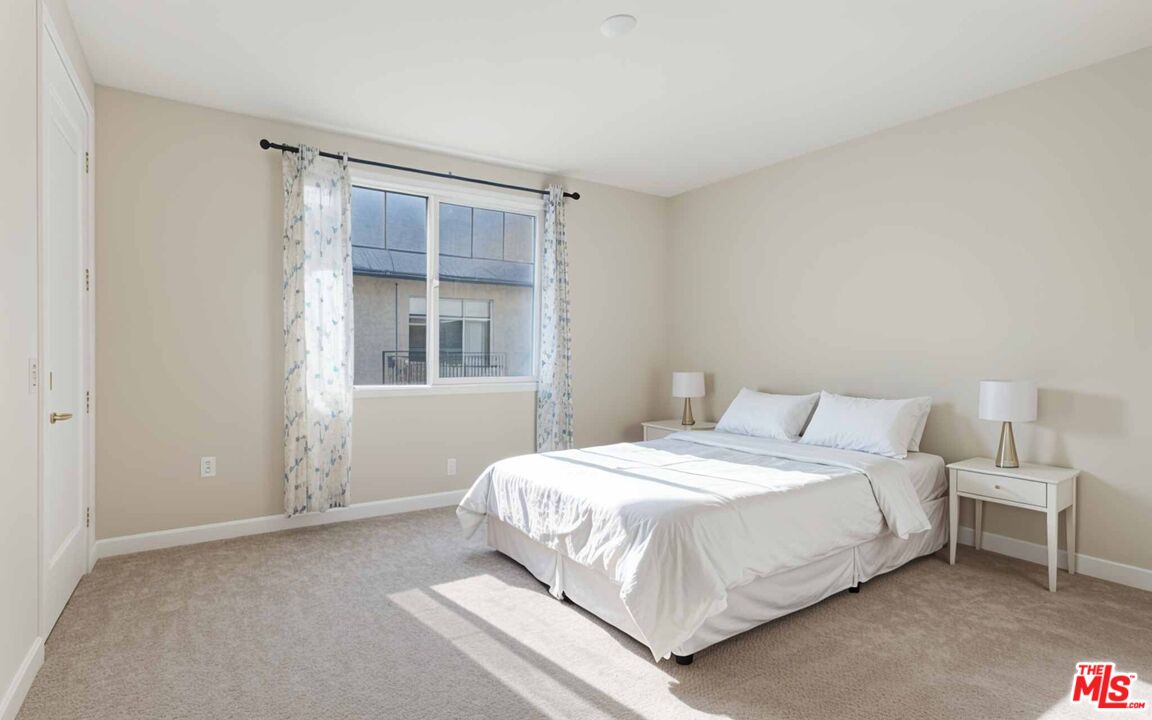 2850 Wagon Wheel Road, Unit 401 Oxnard, CA 93036 - Photo 3 of 31 a bedroom with a bed and a window