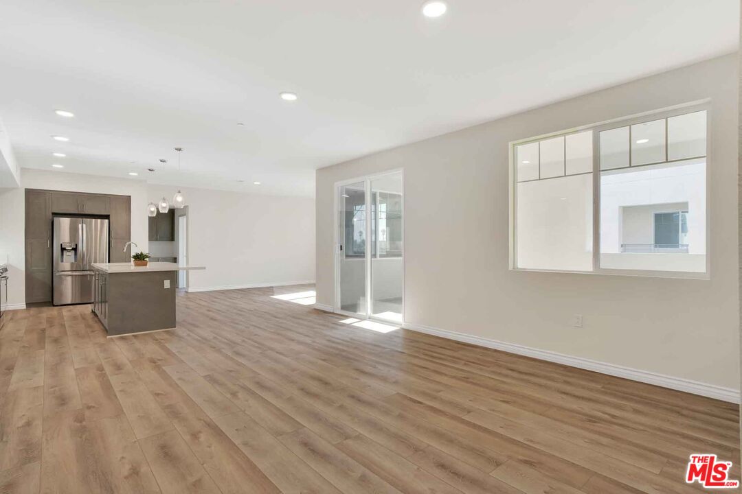 2850 Wagon Wheel Road, Unit 401 Oxnard, CA 93036 - Photo 7 of 31 a view of kitchen with wooden floor and window