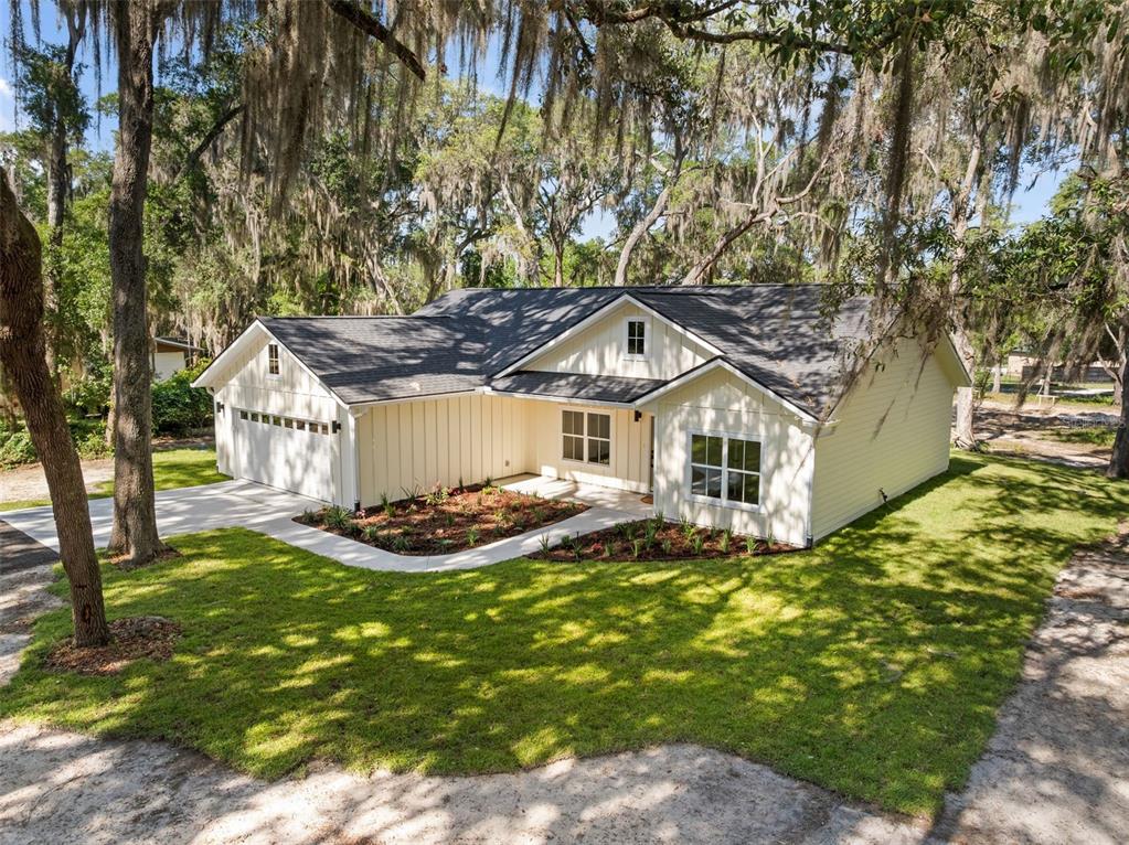 332 Southeast 3rd Avenue Melrose, FL 32666 - Photo 1 of 36 a front view of house with yard and trees in the background