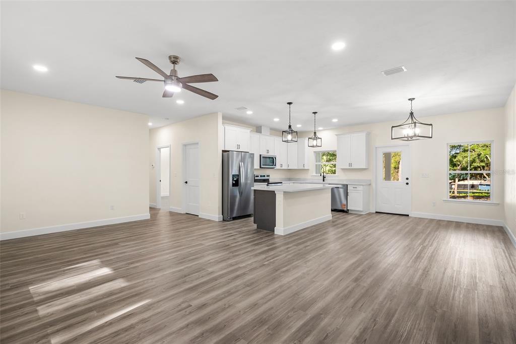 332 Southeast 3rd Avenue Melrose, FL 32666 - Photo 12 of 36 a view of kitchen with wooden floor and window