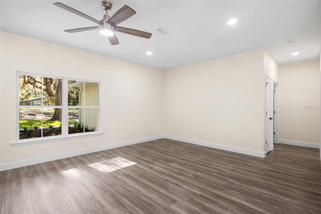 332 Southeast 3rd Avenue Melrose, FL 32666 - Photo 18 of 36 a view of an empty room with wooden floor and a window