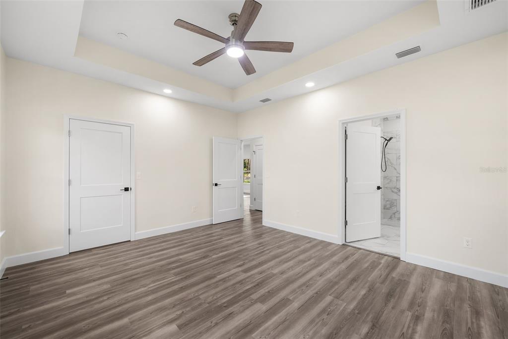 332 Southeast 3rd Avenue Melrose, FL 32666 - Photo 20 of 36 an empty room with wooden floor and a ceiling fan