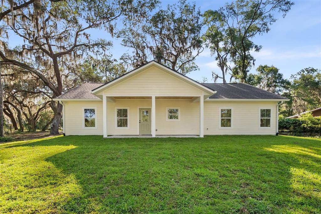 332 Southeast 3rd Avenue Melrose, FL 32666 - Photo 31 of 36 a front view of house with yard and trees in the background