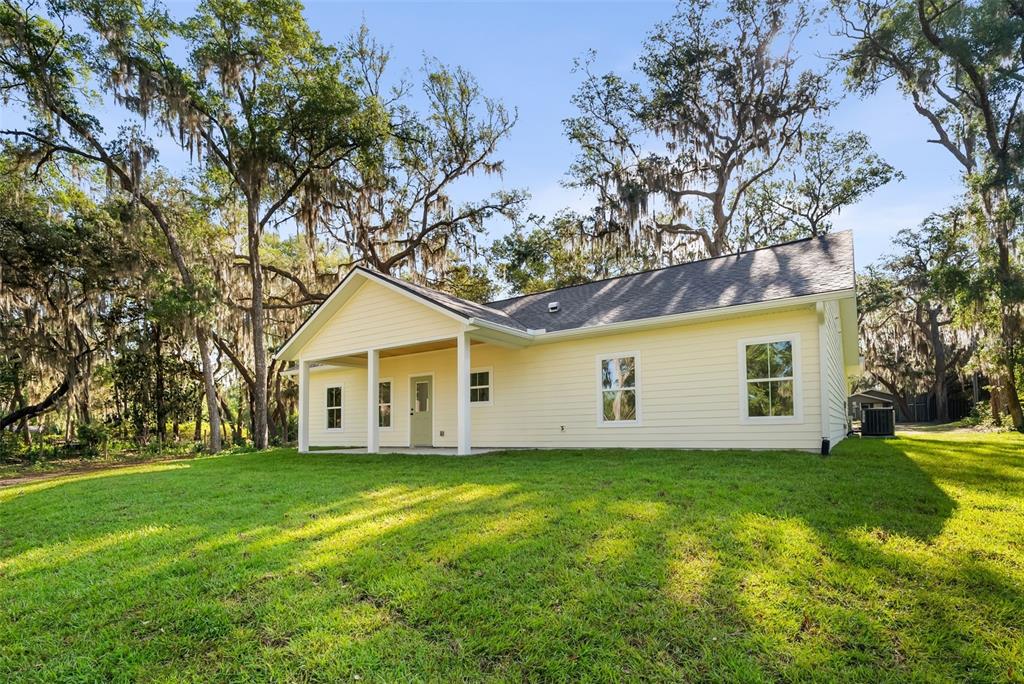 332 Southeast 3rd Avenue Melrose, FL 32666 - Photo 32 of 36 a house with a tree in front of the house
