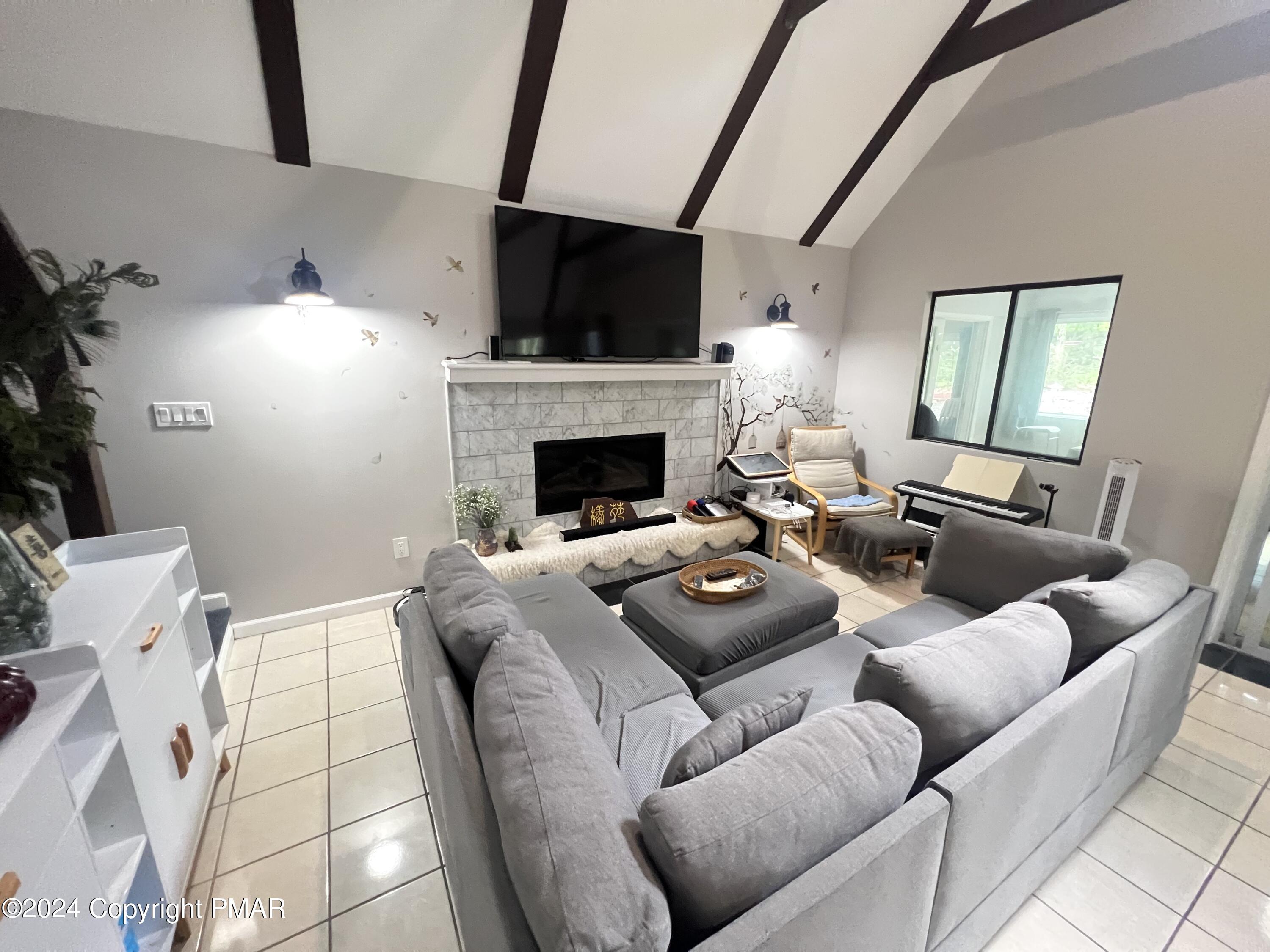 236 Regent Street Bushkill, PA 18324 - Photo 13 of 67 a living room with furniture a fireplace and a flat screen tv