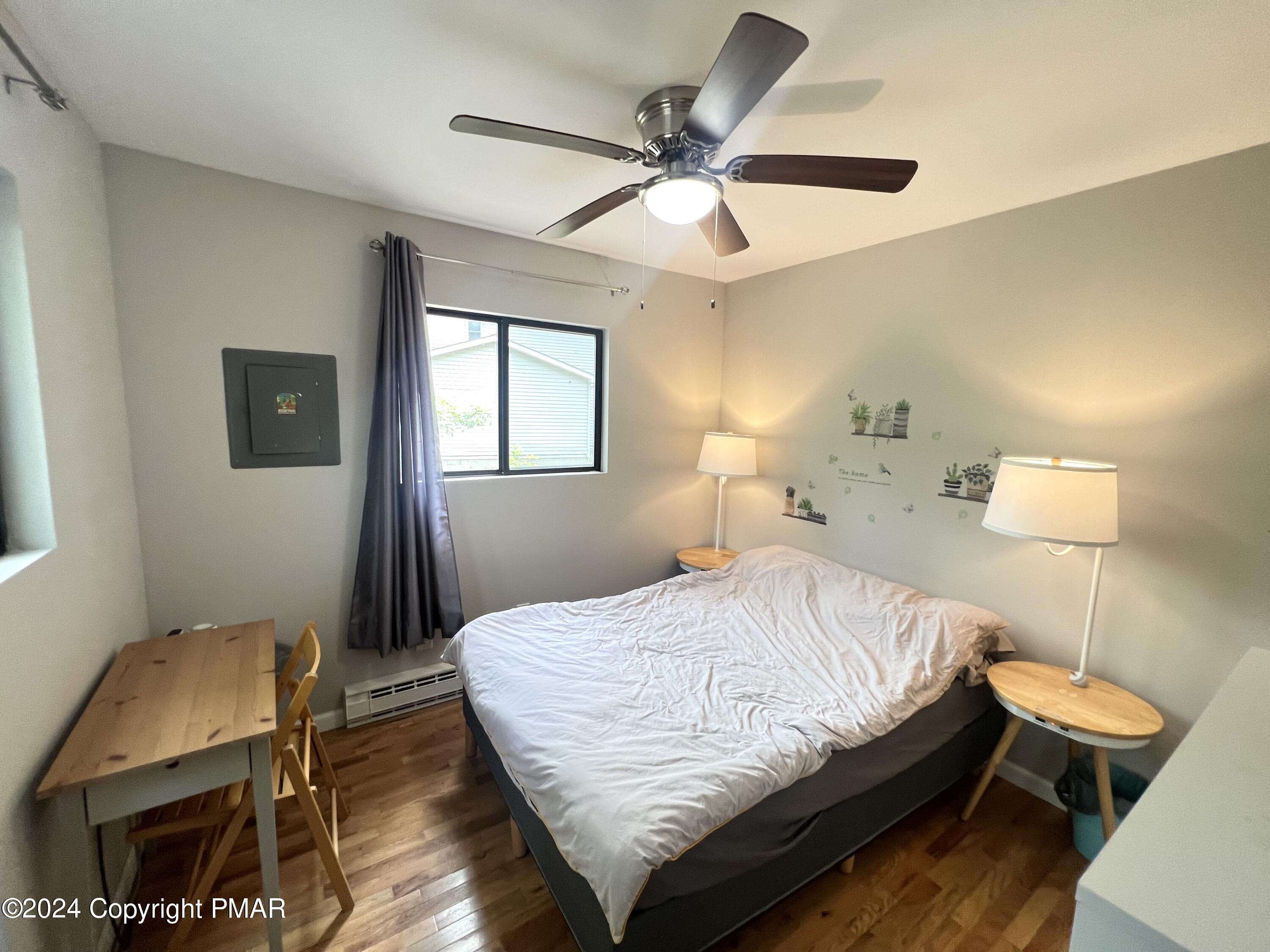 236 Regent Street Bushkill, PA 18324 - Photo 20 of 67 a bedroom with a bed and a chandelier