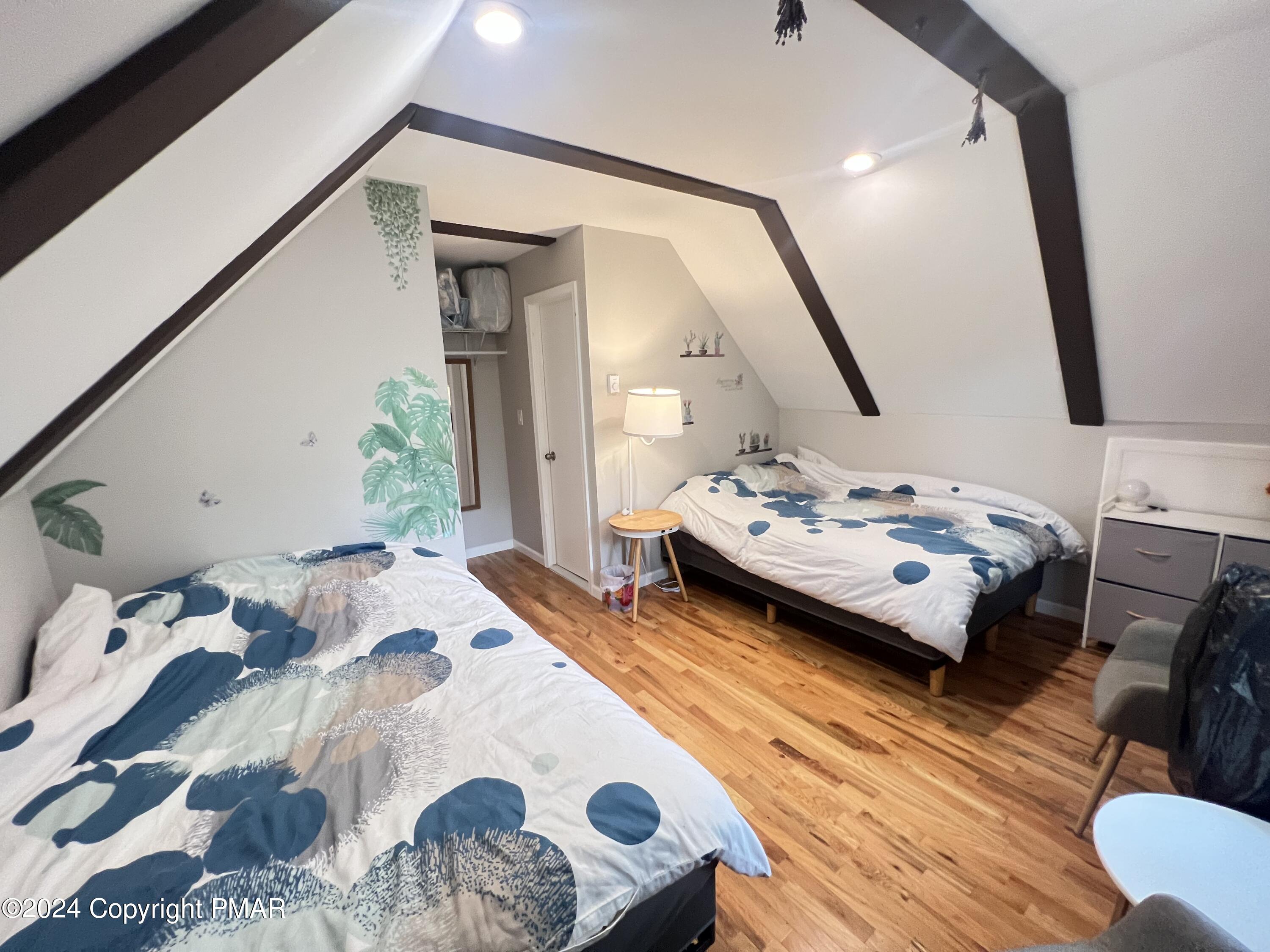 236 Regent Street Bushkill, PA 18324 - Photo 22 of 67 a bedroom with a bed and wooden floor