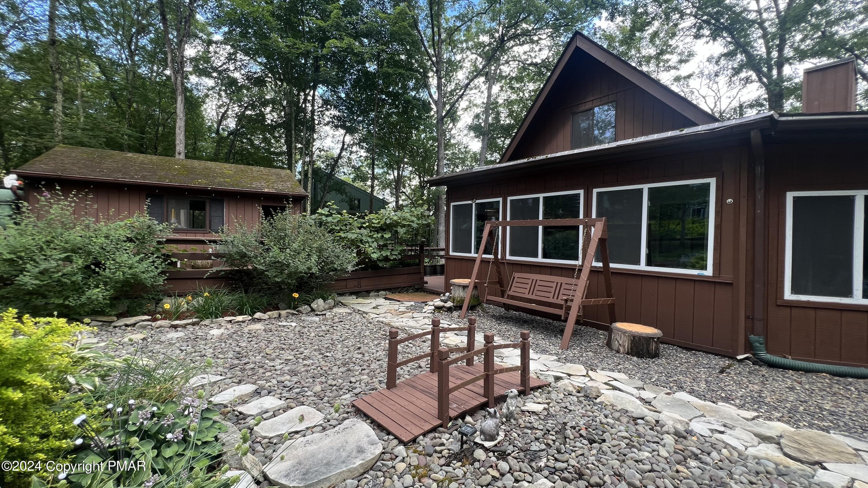 236 Regent Street Bushkill, PA 18324 - Photo 34 of 67 a view of house with backyard outdoor seating and green space