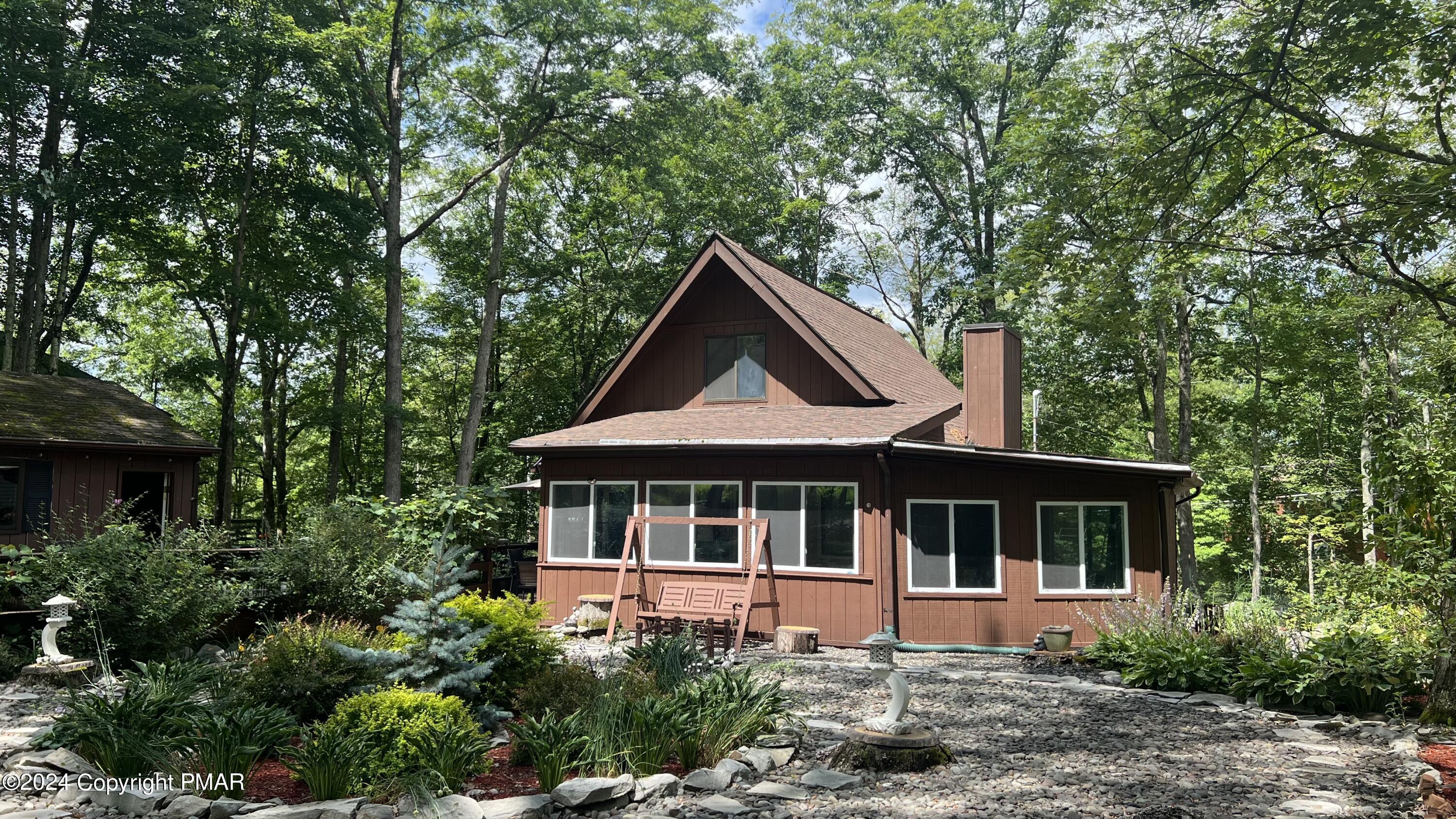 236 Regent Street Bushkill, PA 18324 - Photo 37 of 67 a front view of house with yard and trees around
