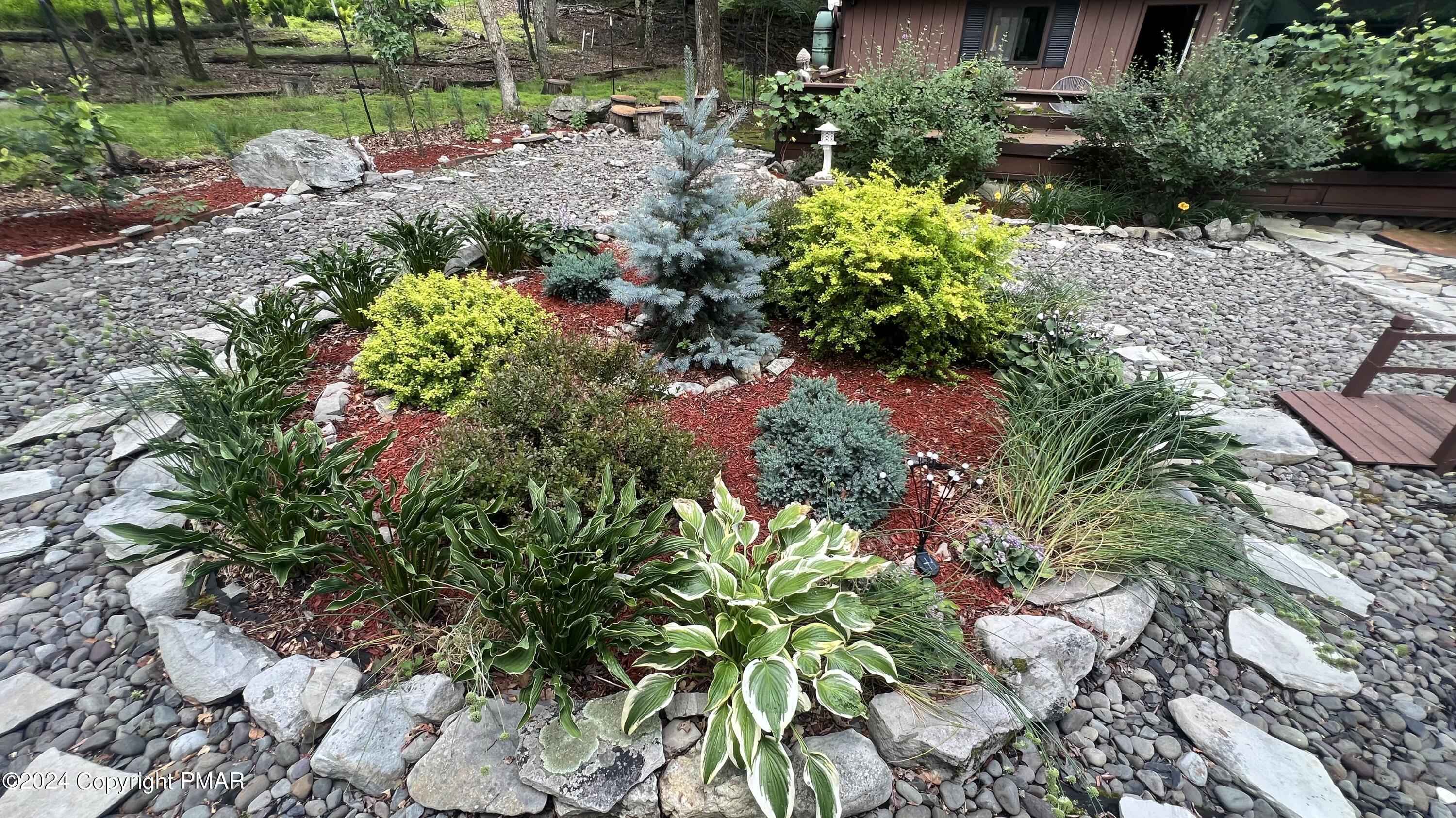 236 Regent Street Bushkill, PA 18324 - Photo 41 of 67 a view of a garden with a lake