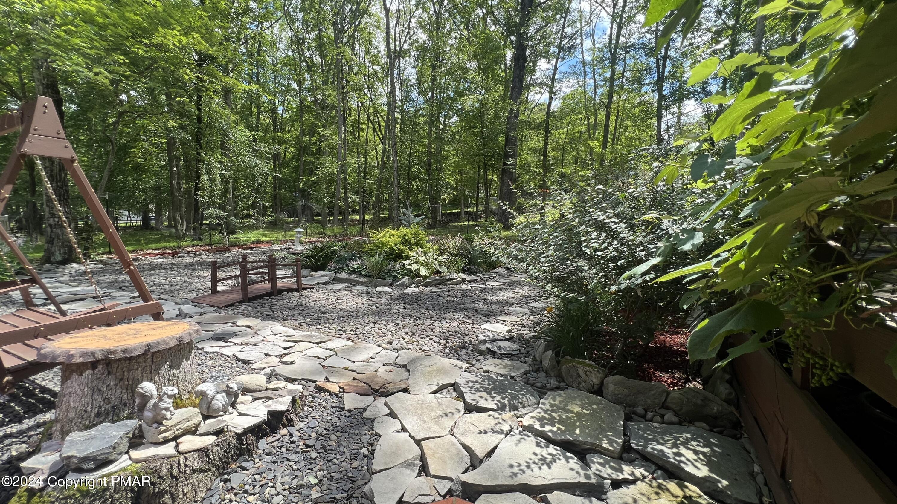 236 Regent Street Bushkill, PA 18324 - Photo 5 of 67 a view of a backyard with plants and trees
