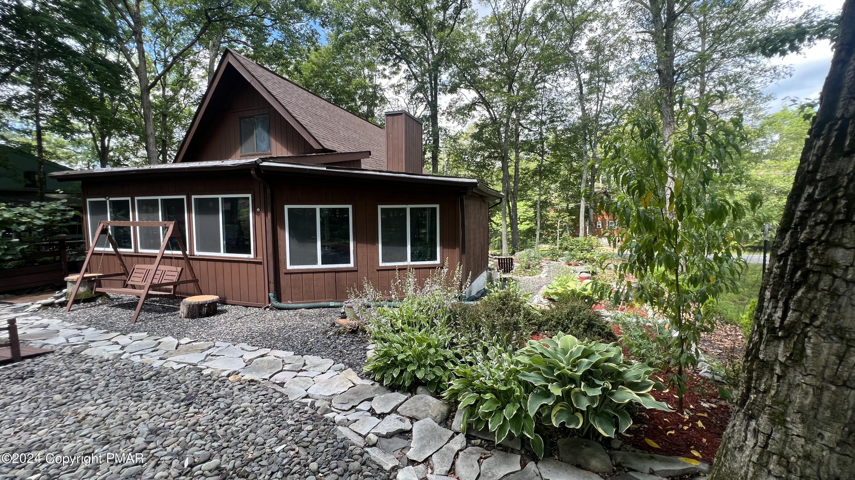 236 Regent Street Bushkill, PA 18324 - Photo 9 of 67 a front view of a house with a garden