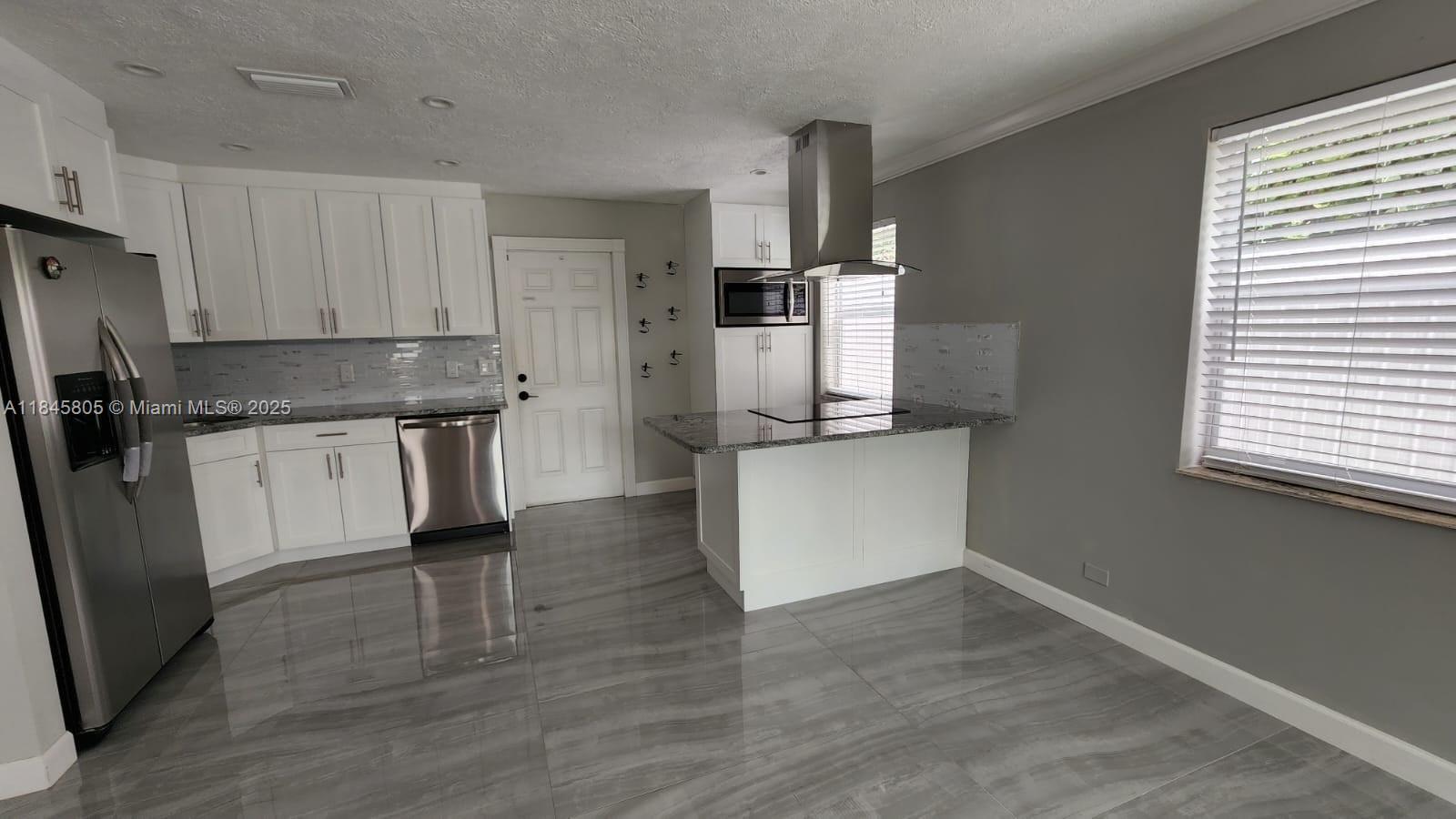 Genesis Lake Worth, FL 33460 - Photo 3 of 7 a kitchen with stainless steel appliances a refrigerator sink and microwave
