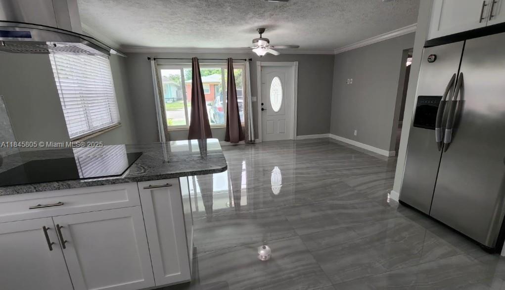 Genesis Lake Worth, FL 33460 - Photo 4 of 7 a kitchen with stainless steel appliances kitchen island granite countertop a refrigerator and a stove