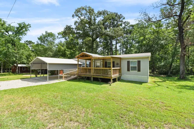 a view of a house with a yard and sitting area