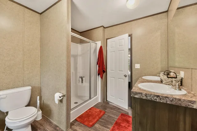 a bathroom with a sink and mirror with toilet