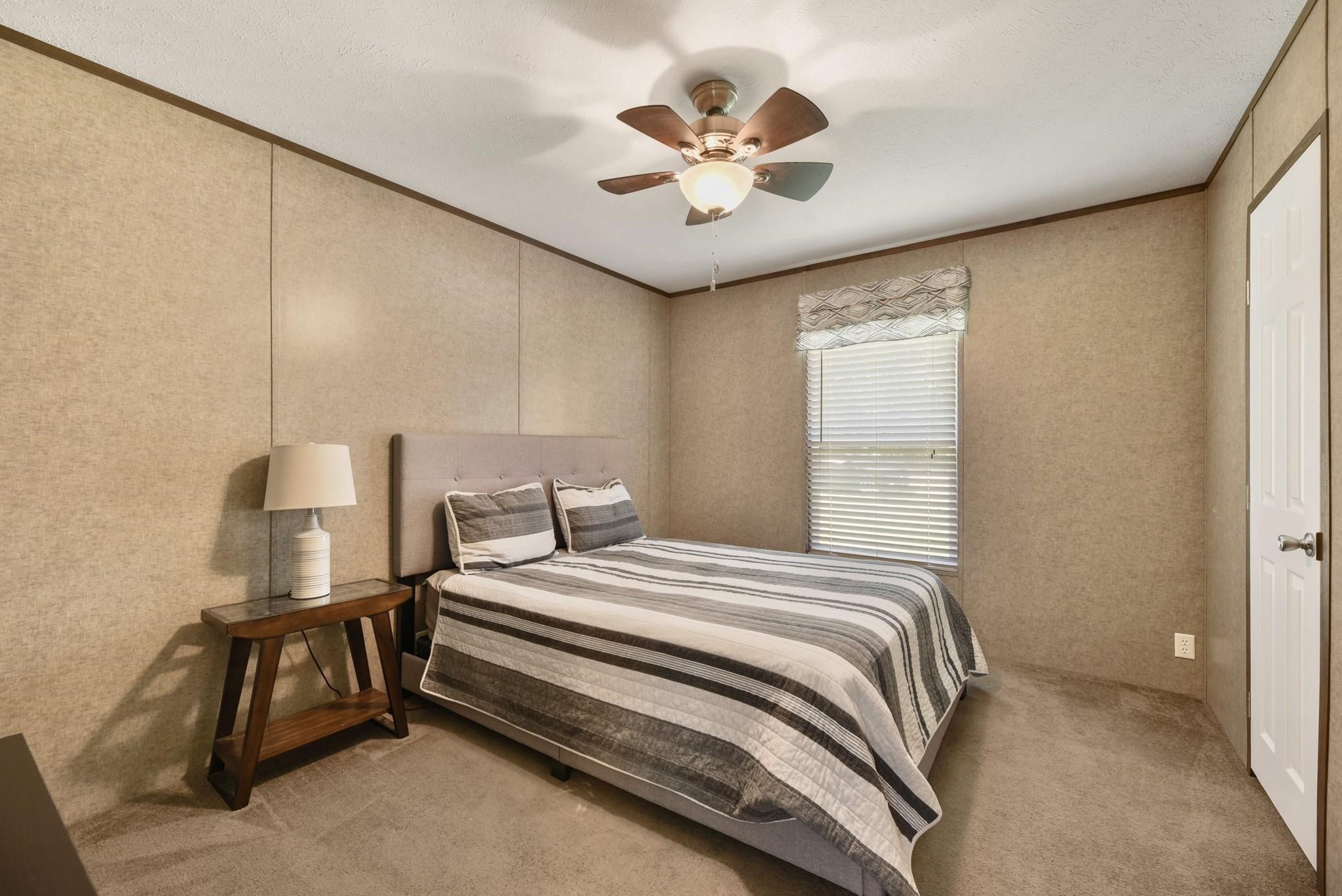 277 Rio Grande Drive Trinity, TX 75862 - Photo 15 of 28 a bedroom with a bed and a ceiling fan