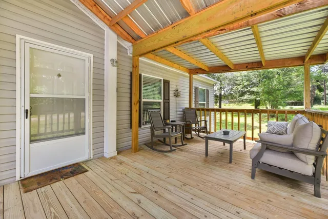 a balcony with furniture and wooden floor