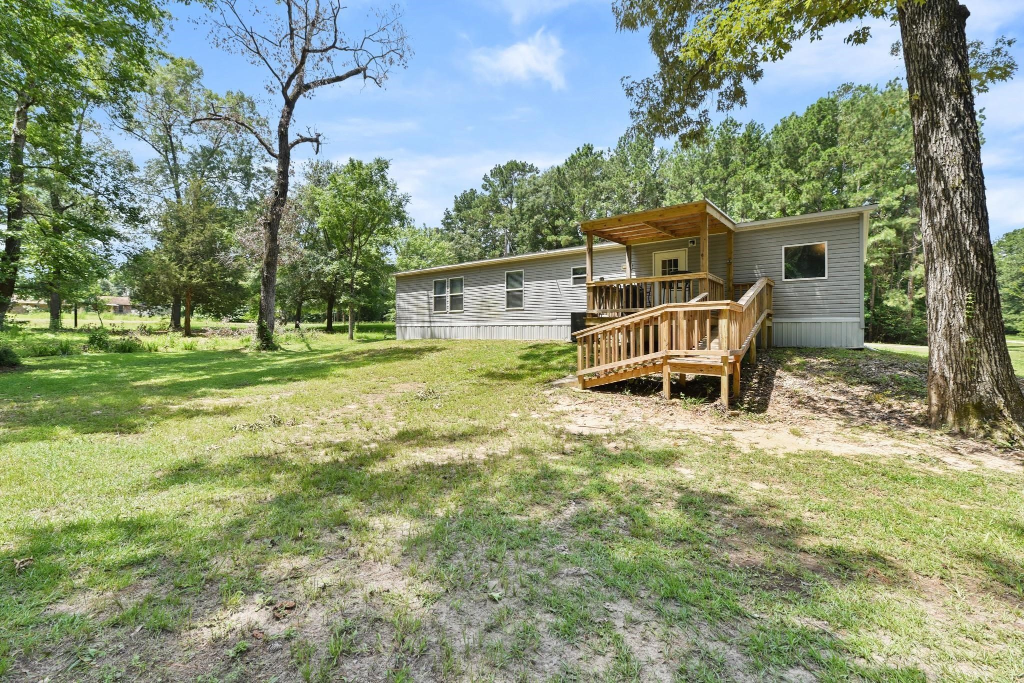277 Rio Grande Drive Trinity, TX 75862 - Photo 22 of 28 a backyard of a house with table and chairs