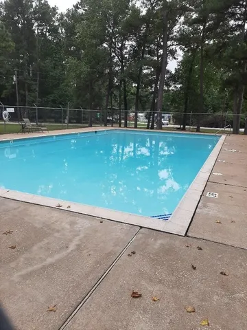 a view of a swimming pool with a yard