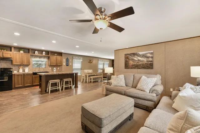 a living room with furniture and kitchen view