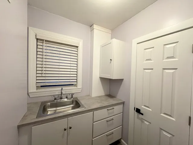 a kitchen with a sink and cabinets