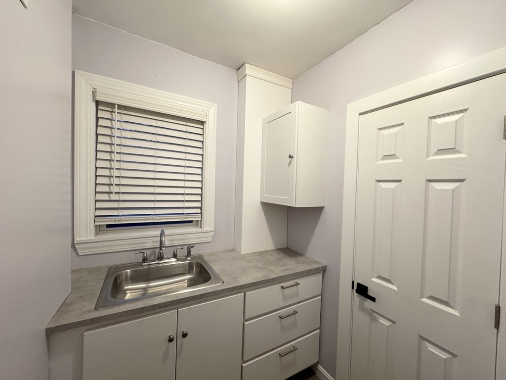 40 Purchase Street, Unit 1 Taunton, MA 02780 - Photo 11 of 14 a kitchen with a sink and cabinets