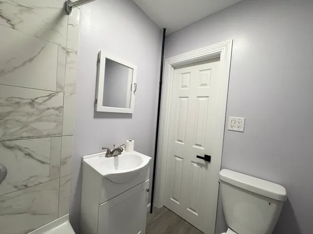 a bathroom with a sink toilet and shower