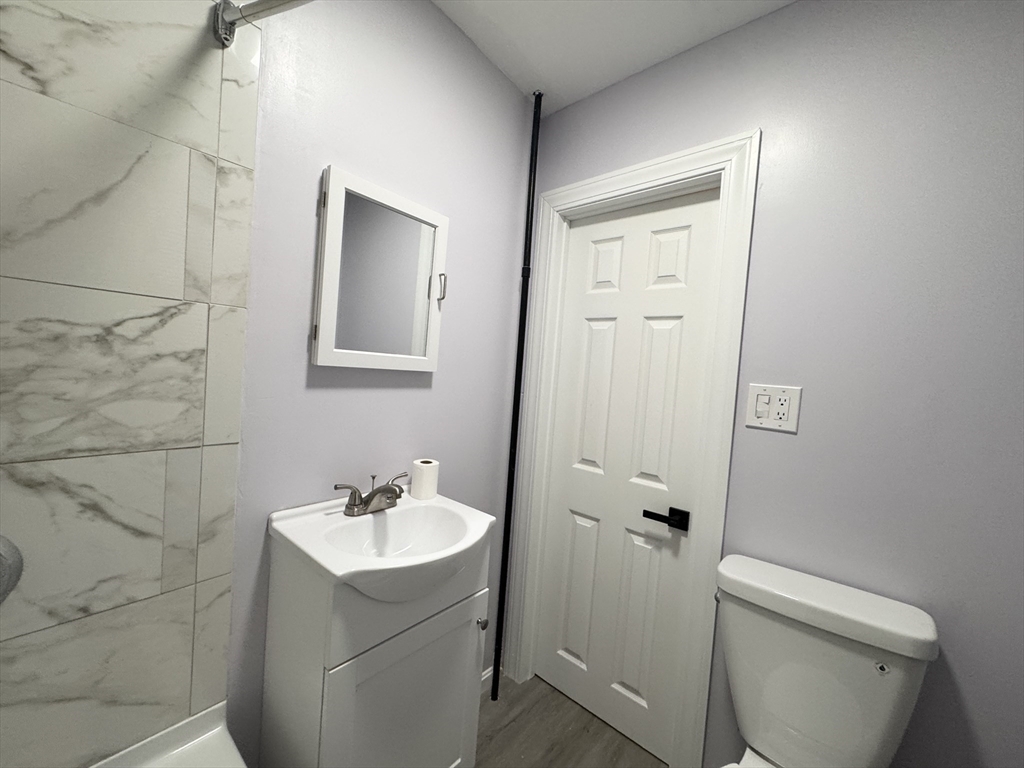 40 Purchase Street, Unit 1 Taunton, MA 02780 - Photo 13 of 14 a bathroom with a sink toilet and shower