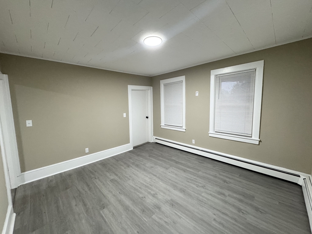 40 Purchase Street, Unit 1 Taunton, MA 02780 - Photo 4 of 14 an empty room with wooden floor and windows