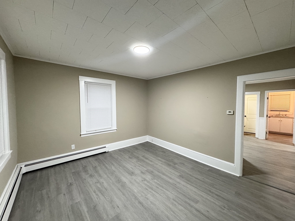 40 Purchase Street, Unit 1 Taunton, MA 02780 - Photo 5 of 14 an empty room with wooden floor and windows