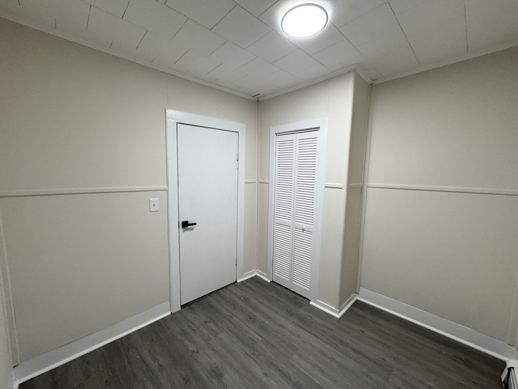 40 Purchase Street, Unit 1 Taunton, MA 02780 - Photo 6 of 14 an empty room with wooden floor and windows