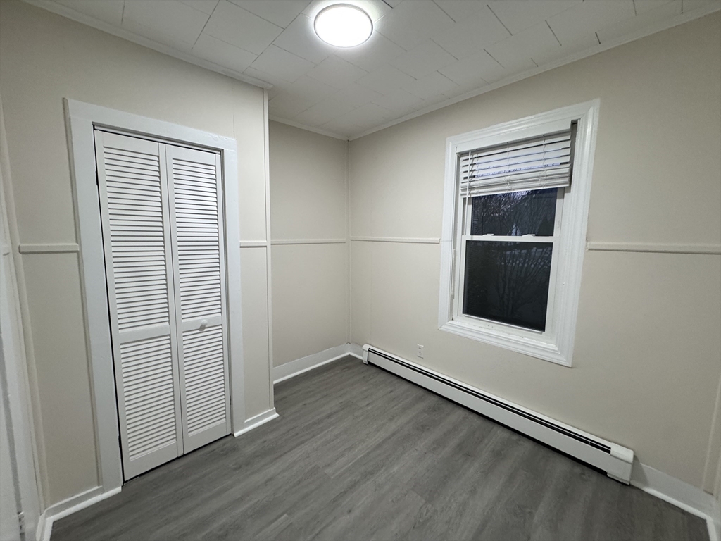 40 Purchase Street, Unit 1 Taunton, MA 02780 - Photo 7 of 14 an empty room with wooden floor closet and windows