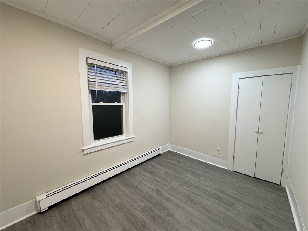 40 Purchase Street, Unit 1 Taunton, MA 02780 - Photo 8 of 14 a view of an empty room with wooden floor and a window